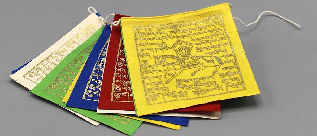 Prayers flags depicting mythical creatures and ancient scriptures